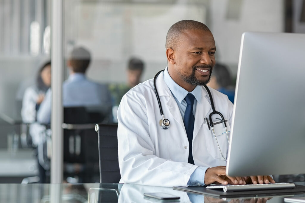 Doctor working on computer at his desk